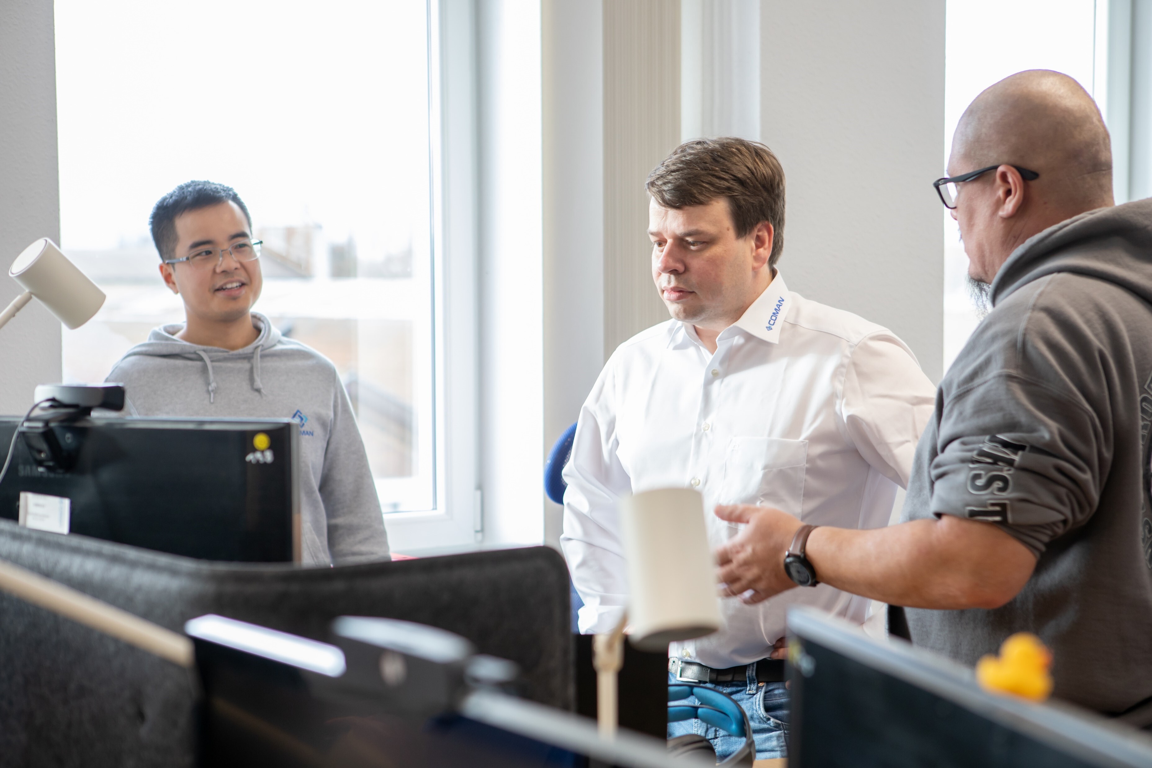 COMAN Team Standing together in Office